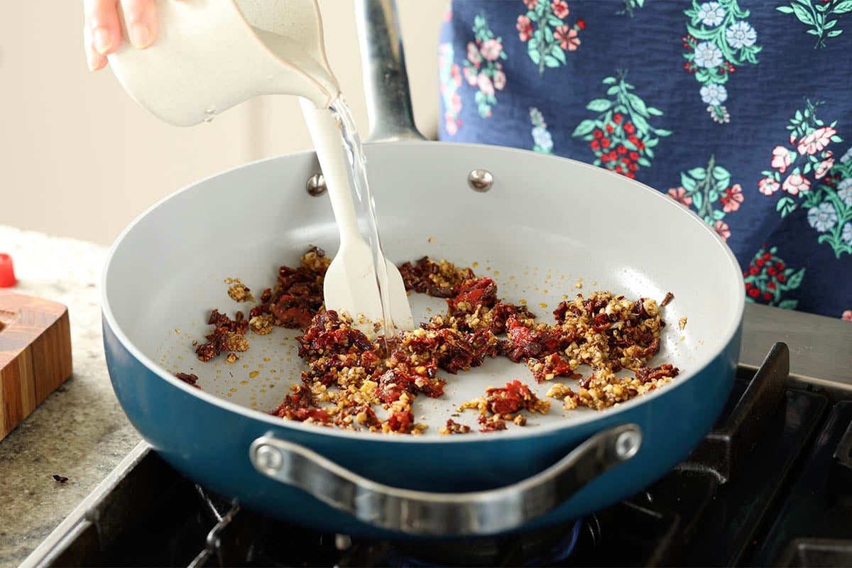 adding water to the pan
