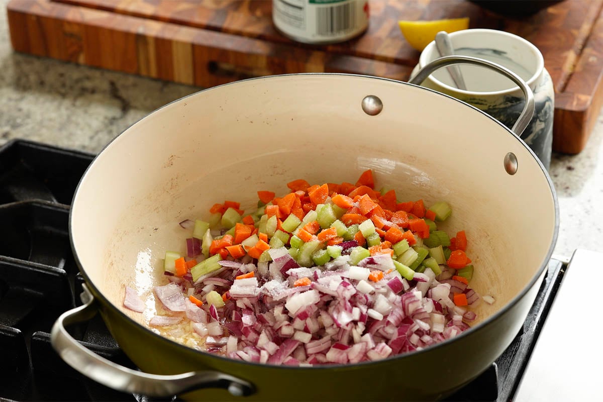 adding onion, carrots, and celery to the pan