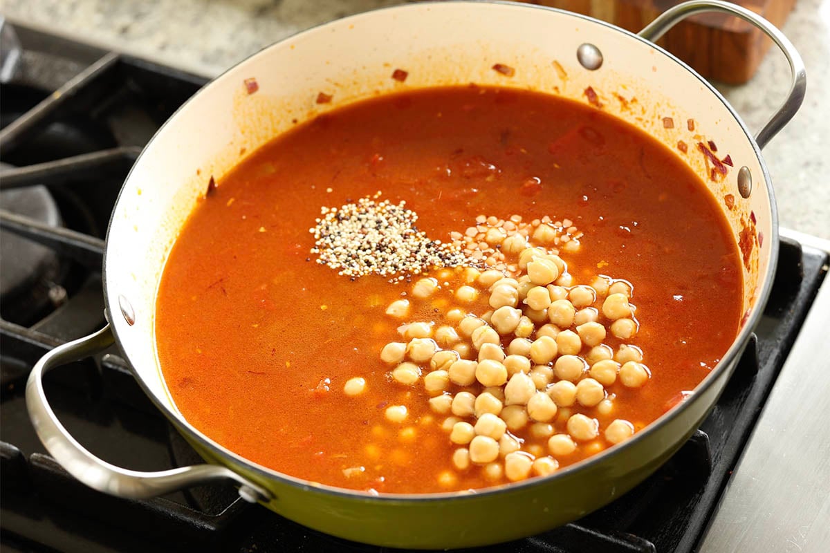 adding quinoa, lentils, and chickpeas to the pan