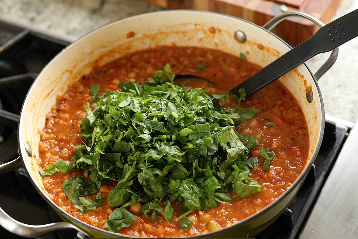 adding greens to the pan