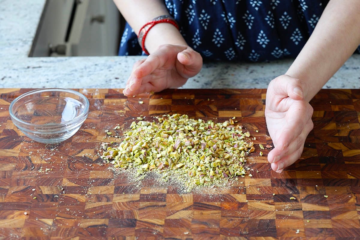 chopped pistachios on a cutting board