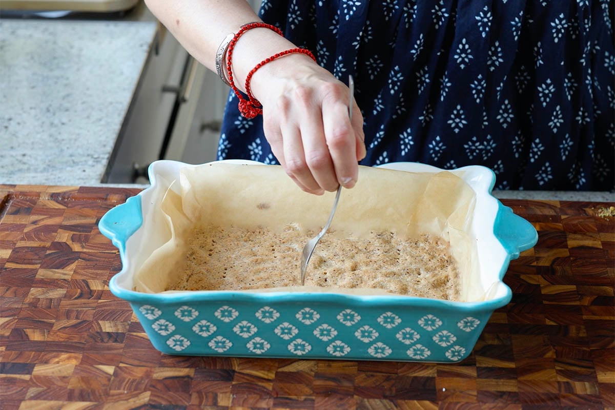 making holes in the crust dough with a fork