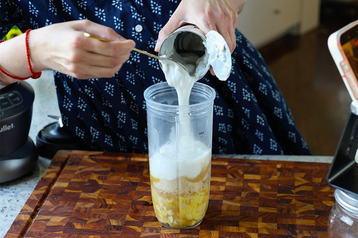 adding saffron cream ingredients to the blender