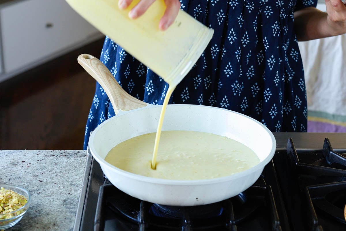 adding saffron cream to the pan