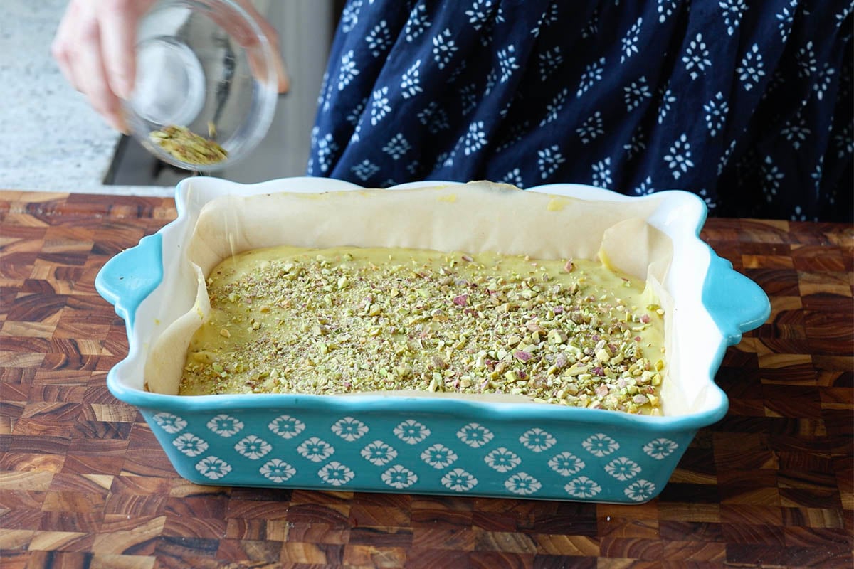 topping the saffron cream with more chopped pistachios