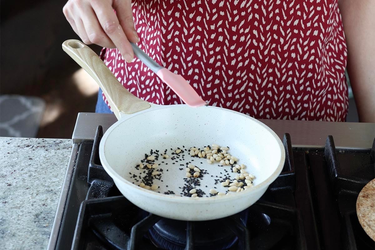 pine nuts and sesame seeds in the pan before toasting