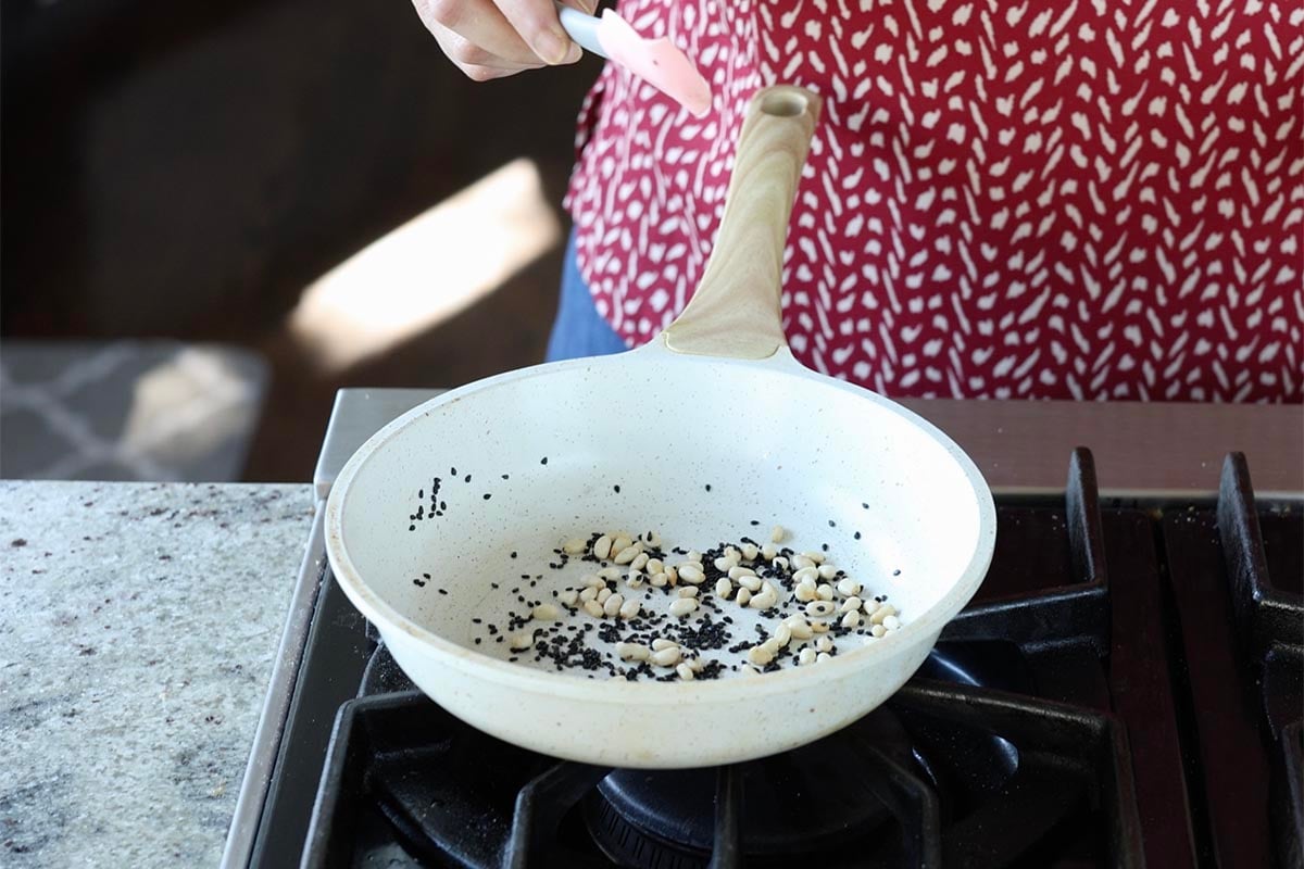 pine nuts and sesame seeds in the pan after toasting