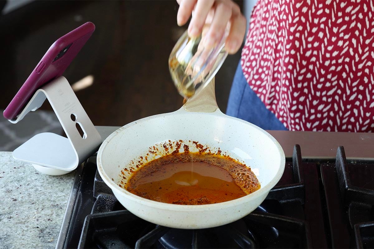 adding maple syrup to the pan