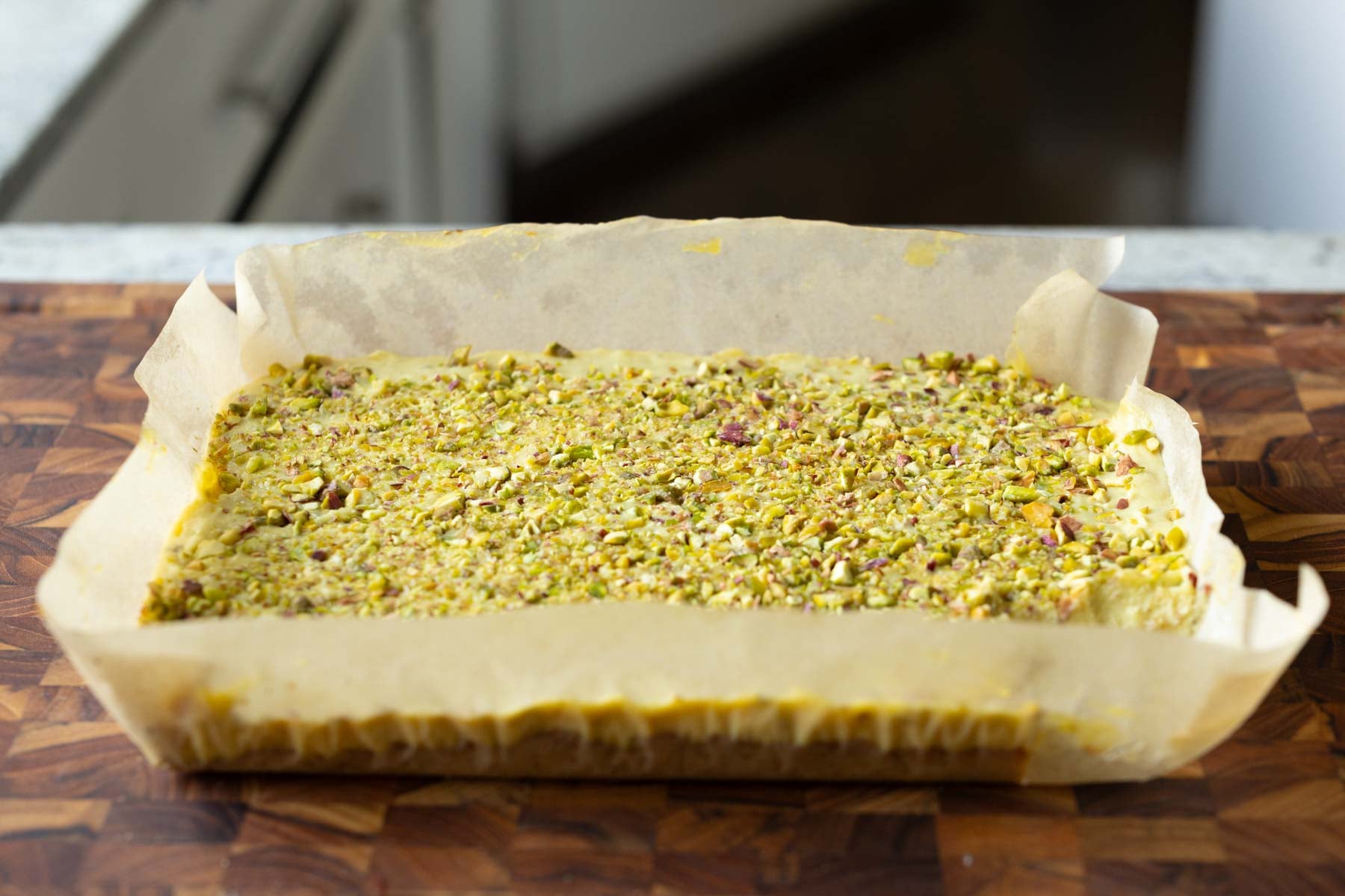 kesar pista bars on the cutting board before slicing
