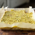 kesar pista bars on the cutting board before slicing