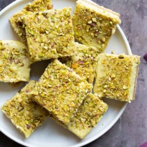 sliced saffron pistachio bars on a white plate