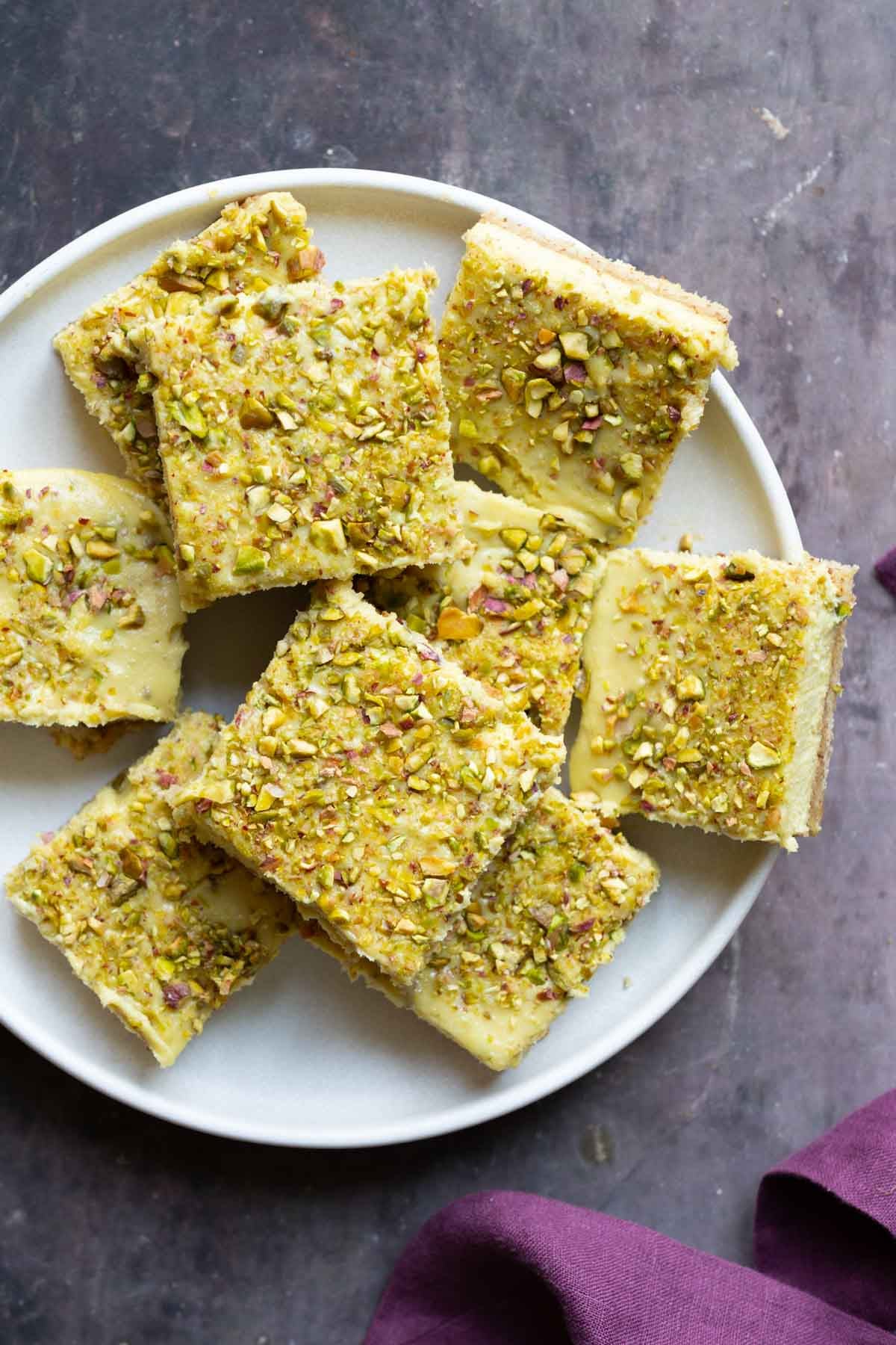 sliced saffron pistachio bars on a white plate