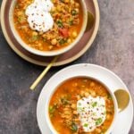 bowls of Moroccan harira garnished with yogurt and red pepper