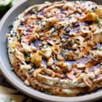 close-up of whipped feta topped with the hot honey and garlic and seeds