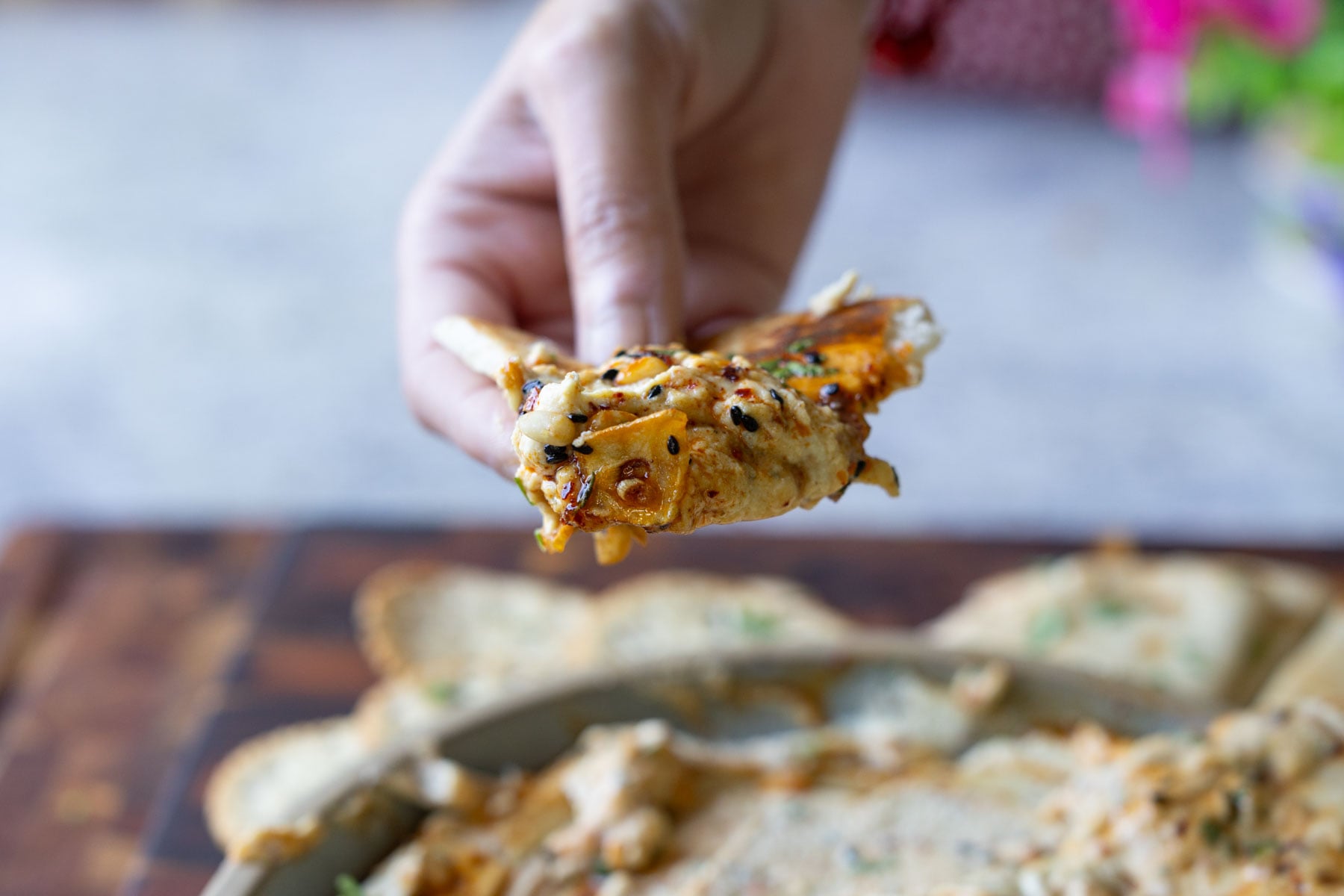 piece of pita scooping up a bite of the whipped feta