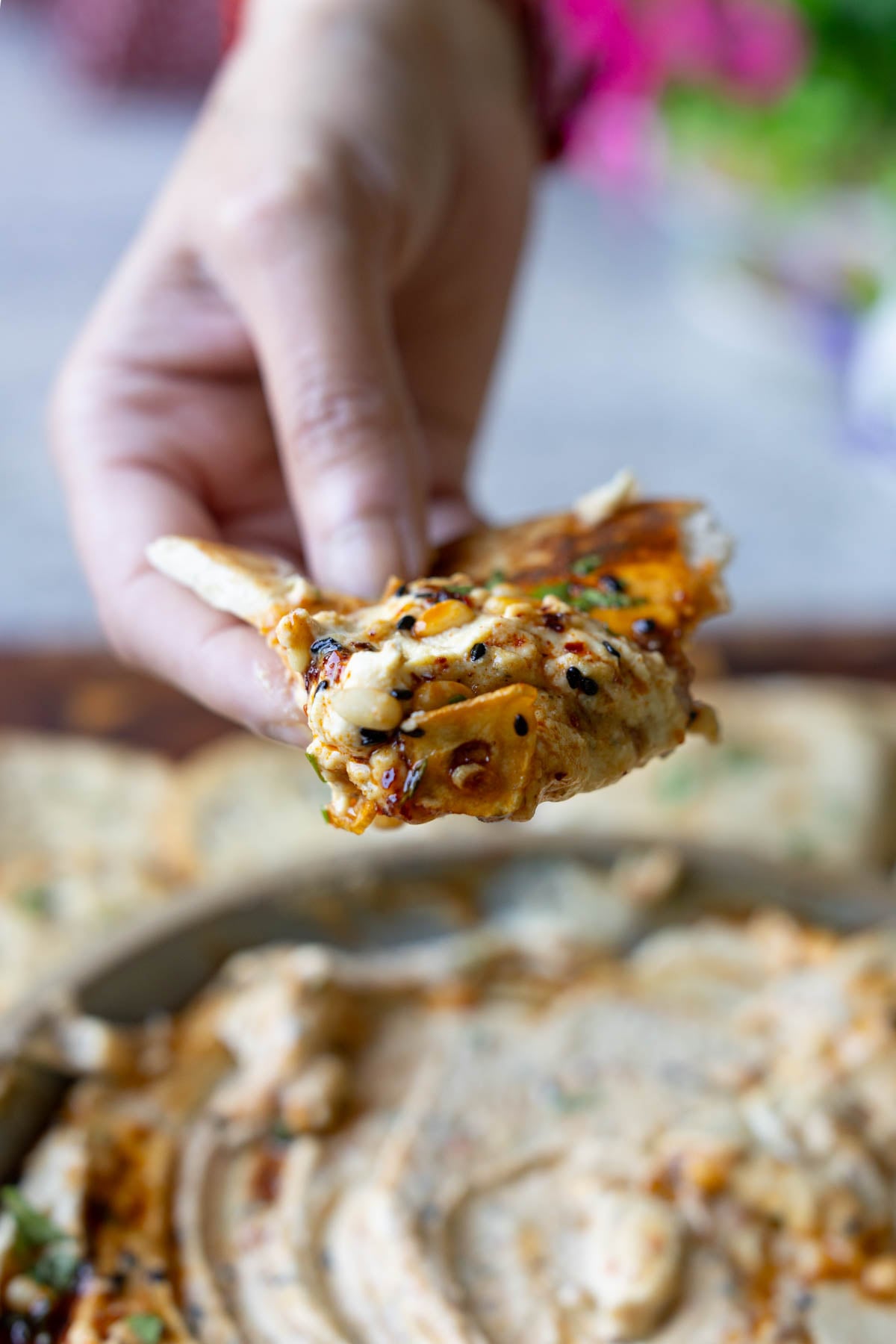 piece of pita scooping up a bite of the whipped feta